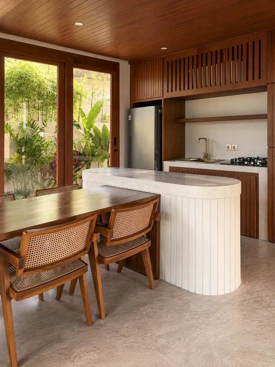 Kitchen island in white terrazzo under timber ceiling