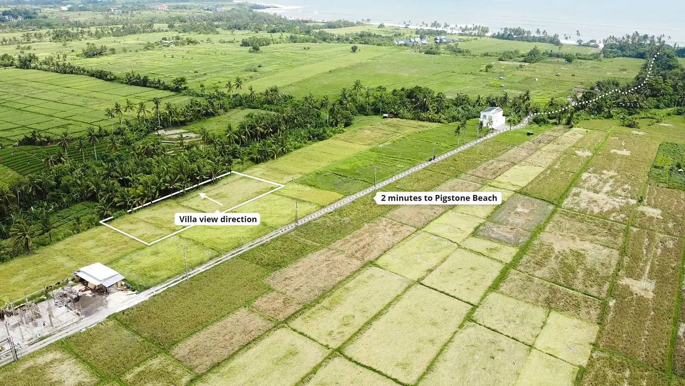 Drone photo of the Luxury Huts plot in Kedungu — villa view direction across preserved rice fields, 2 minutes to Pigstone Beach
